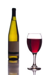 bottle and glass of red wine on white background