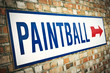 A Paintball sign on the brick wall in London.