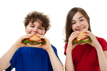 Wall Mural - Kids eating big sandwiches isolated on white