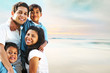 © Monart Design - Family Smiling and Embracing Outdoor Beach Portrait