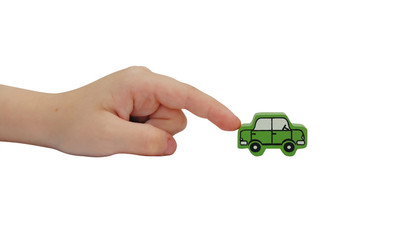 finger pushing on a wooden car isolated on white