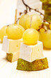 Canape with pear, soft cheese and grape