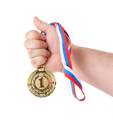 Gold medal in hand isolated on white