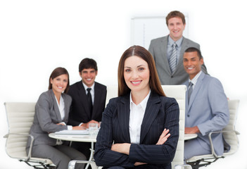 Wall Mural - Charismatic female executive sitting in front of her team