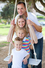 Wall Mural - Happy family swinging