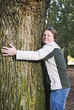 © Andrew Lever - happy smiling outdoor man hugging a tree