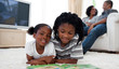 © WavebreakMediaMicro - Cute siblings reading lying on the floor
