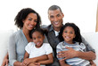 © WavebreakMediaMicro - Loving african american family sitting on the sofa together