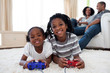 © WavebreakMediaMicro - Happy siblings playing video game