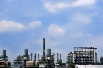 Oil industry installation, metal skyline blue sky