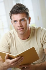 Poster - Man with book looking at camera