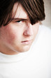 © Sascha Burkard - teen male looking into camera angry frustrated