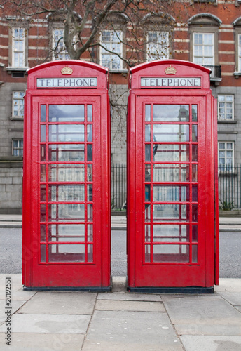 Fototapeta na wymiar A pair of typical red phone booths in London