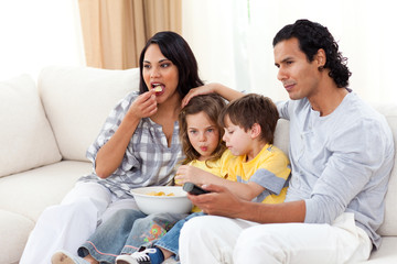 Wall Mural - Lively family watching TV on sofa