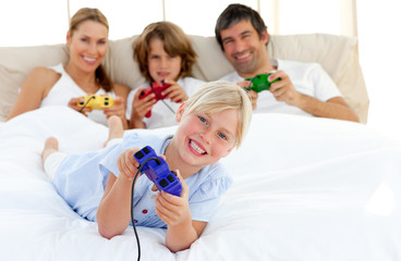 Canvas Print - Little blond girl playing video game with her family