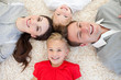 © WavebreakMediaMicro - Happy family lying on the floor