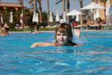 Fototapeta Na ścianę - little girl floating in the pool