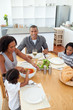 © WavebreakMediaMicro - Ethnic family dining together