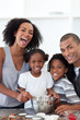 © WavebreakMediaMicro - Jolly family making cookies together