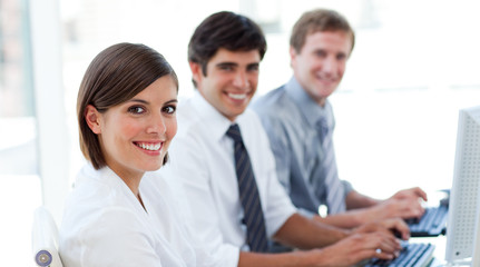 Wall Mural - Enthusiastic business people working at computers