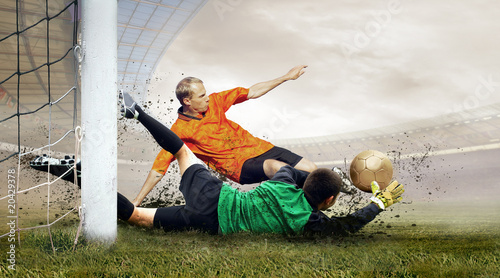 Fototapeta do kuchni Shoot of football player and jump of goalkeeper on the field of