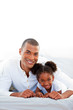 © WavebreakMediaMicro - Attentive father and his daughter smiling at the camera