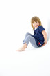 © Monkey Business - Young Girl Sitting In WhiteStudio