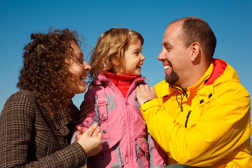 Wall Mural - Portrait of happy family against blue sky