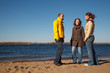 © Pavel Losevsky - Three young men stand on bank of river sunny autumn day.