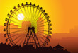Silhouette of a ferris wheel at sunset.