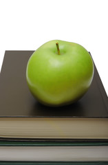 green apple on stack of book