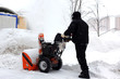 © konstantant - Snowblower in city under snowfall
