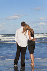 Romantic Man and Woman Couple Embracing On A Beach