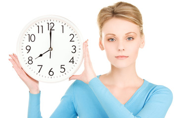 woman holding big clock