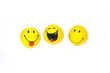 Three funny yellow smiles  isolated on white