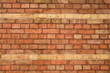 A red brick wall with two rows in ochre