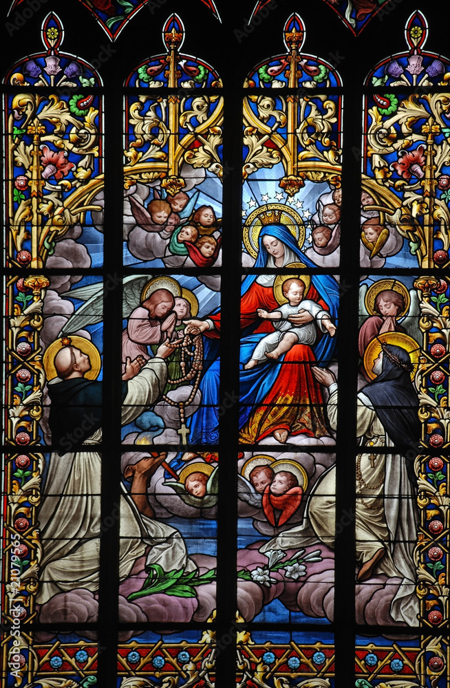 holy virgin Mary and Jesus with rosary on stained glass window Stock ...