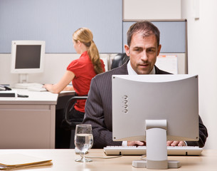 Wall Mural - Businessman typing on computer at desk