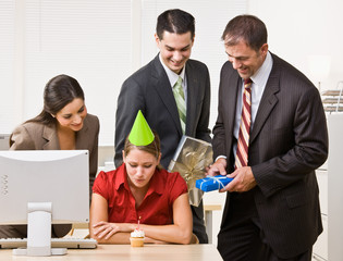 Wall Mural - Businesswoman blowing out birthday candle