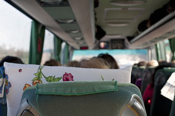 Tourists in a luxury chartered bus on road during a tour