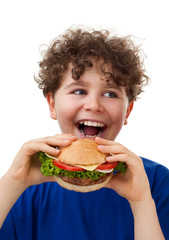 Poster - Boy eating big sandwich isolated on white