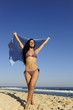 freedom: woman with beach towel against blue sky