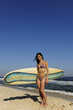 attractive sufer girl holding her board