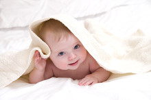Cute Baby Under A White Towel