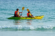 © travelview - father and son are padelling with a canoe on open sea