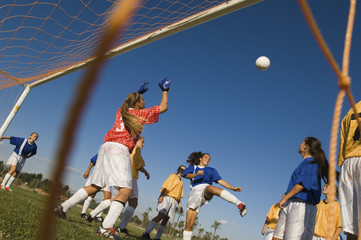 girl (13-17) waiting to score with soccer ball