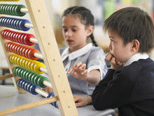 Elementary Students Using Abacus In Classroom