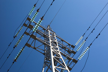 Metal electric pole on a blue sky background