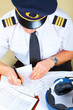 © Monika Wisniewska - Airline pilot filling in papers