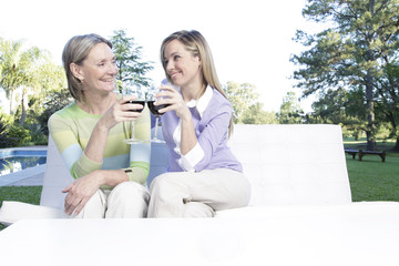 Wall Mural - Mother and daughter drinking wine